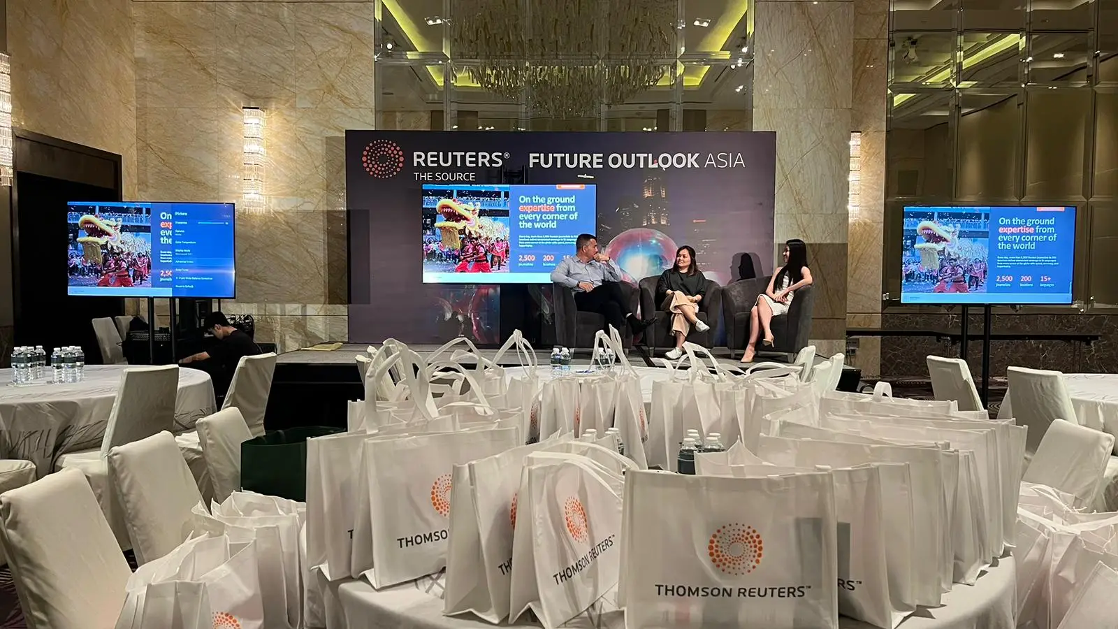 85 Inch TV rental as presentation screens for Thomson Reuters corporate event. Pictured with truss mount and spandex wrap.