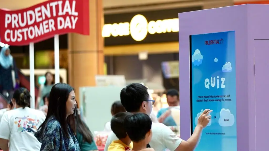 55-inch touch screen TV rental setup for Prudential Customer Day at Suntec City Atrium in Singapore.