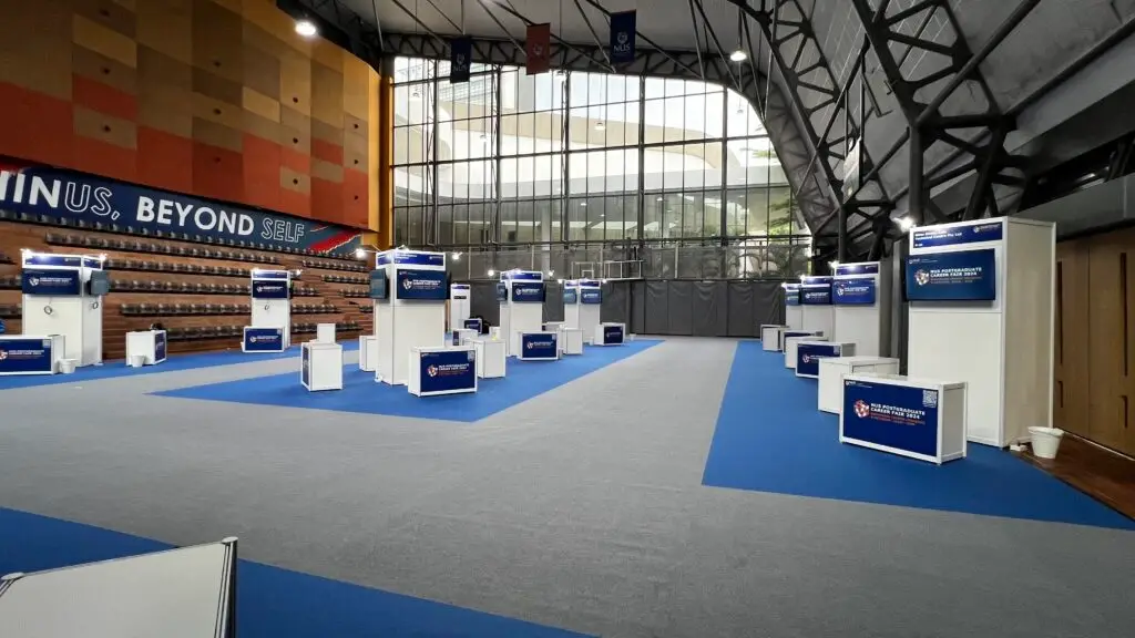 Finished TV setup at NUS Career Fair booth with standardised display system.