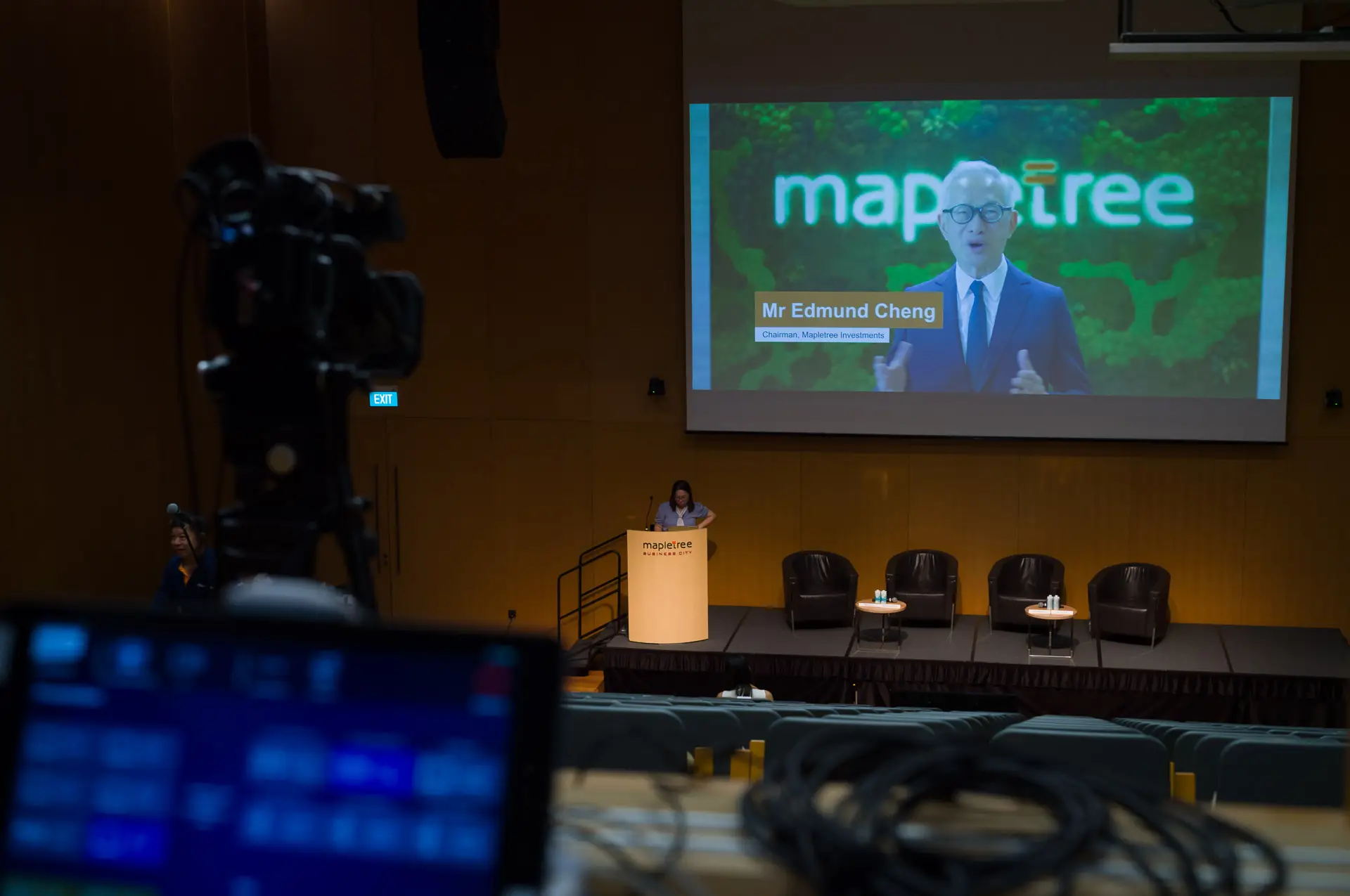 Behind-the-scenes view of a Mapletree corporate event av production setup with live streaming webcasting on custom platform, and AV crew